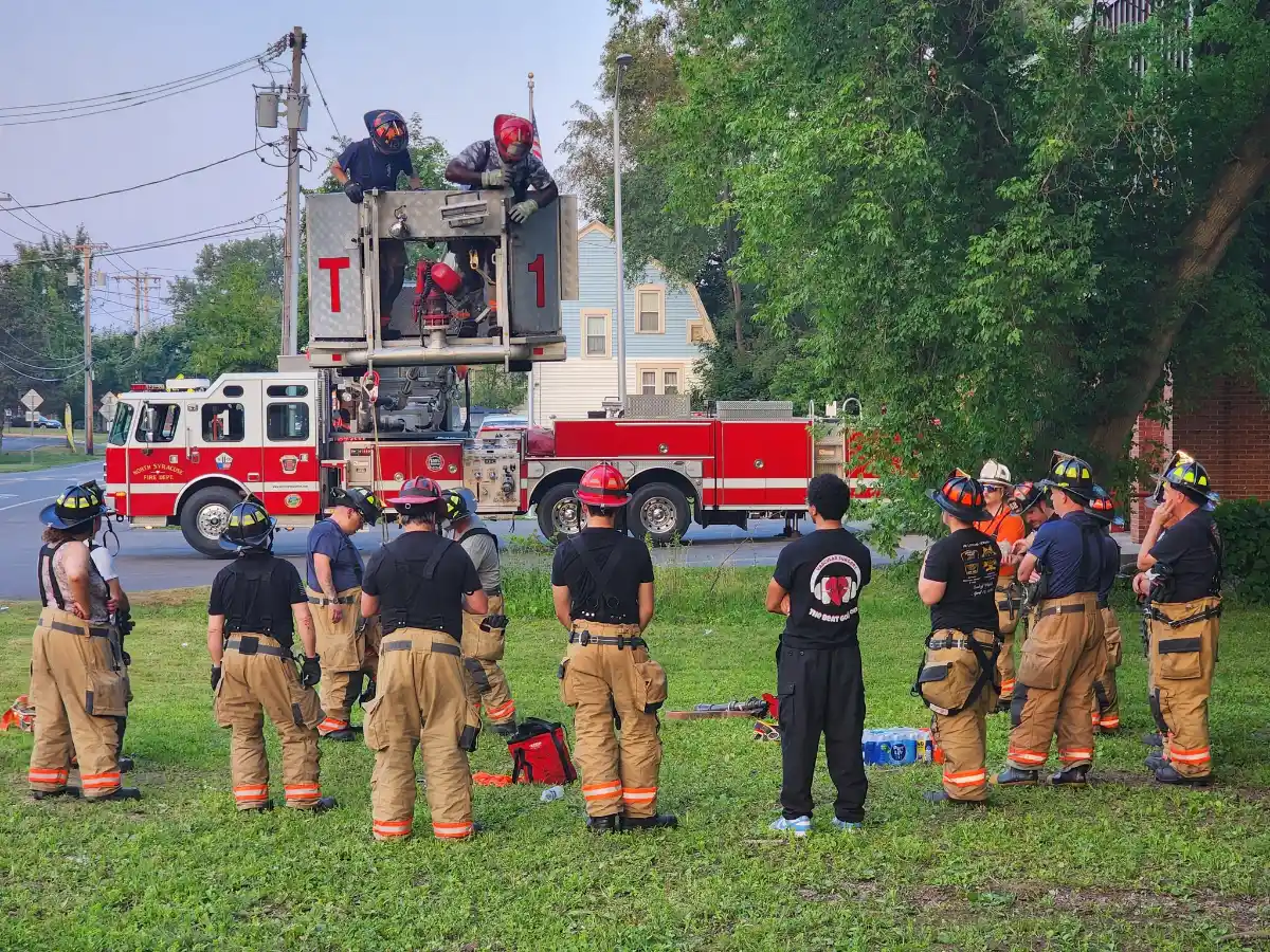 Firefighters practicing in the fire truck bucket